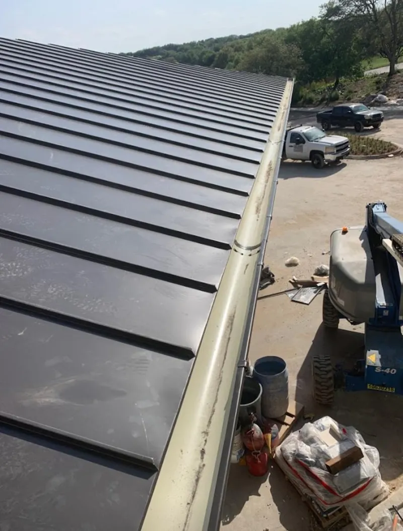 Standing seam panel and gutter detail on a metal roofing jobsite in Scottsburg